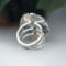 back view, large oval wild horse magnesite gemstone silver statement ring, bezel set with stamped cutout wire accent